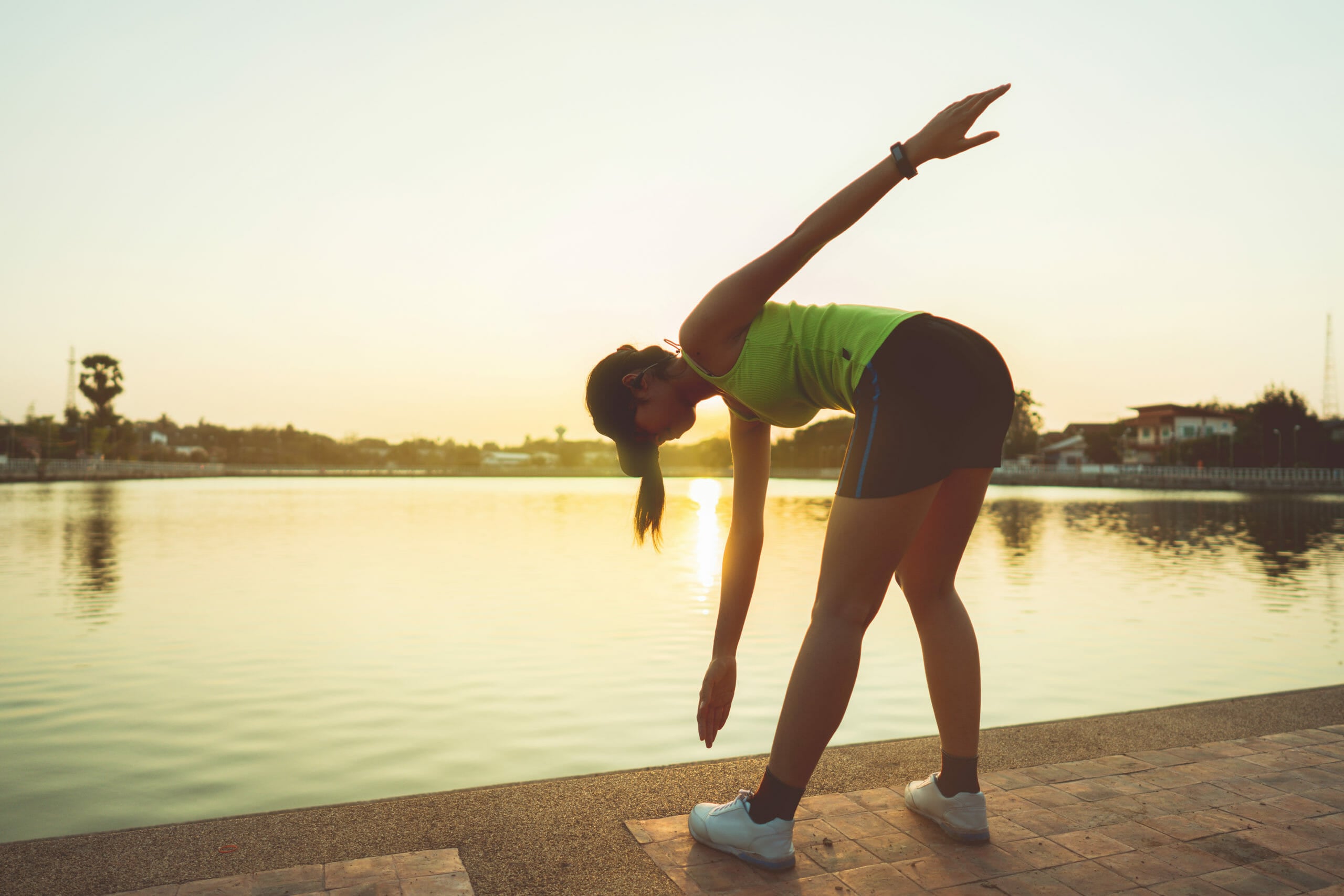 Asian women warm up before running at the park.