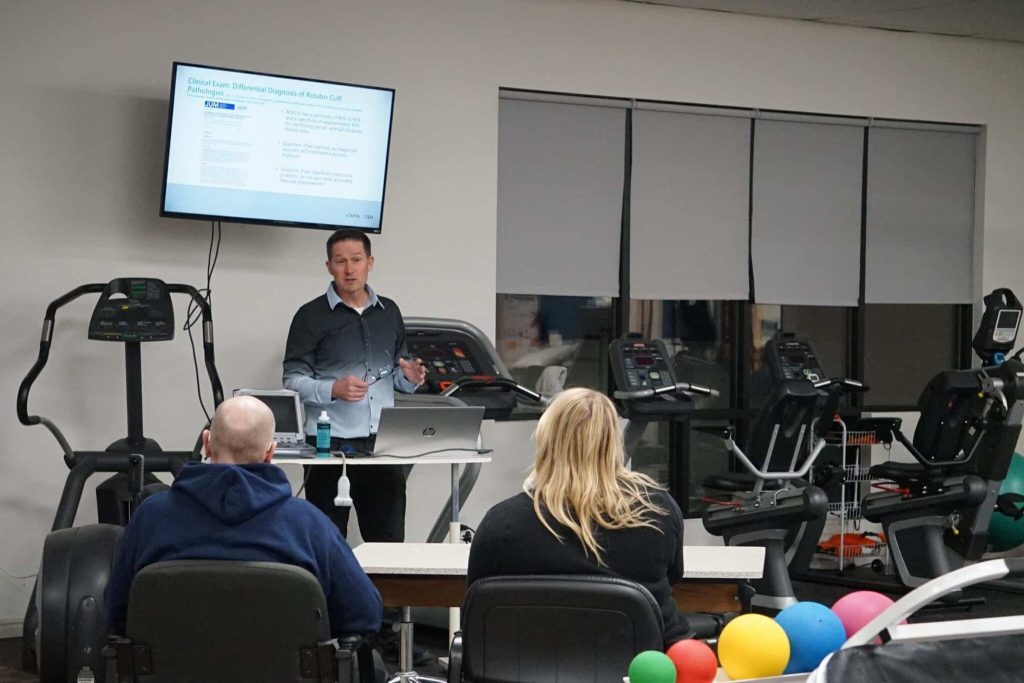 A Mountain Land physical therapist leading a clinical education session